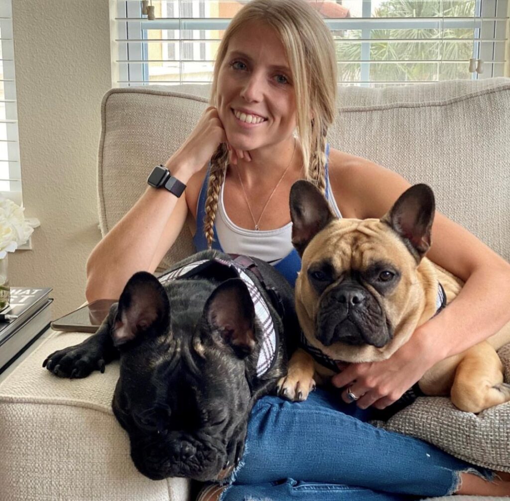 young woman with two Frenchie dogs